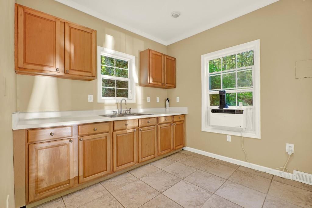 438 East Price Creek Road Jasper, GA 30143 - Photo 46 of 64 a kitchen with granite countertop a sink window and cabinets