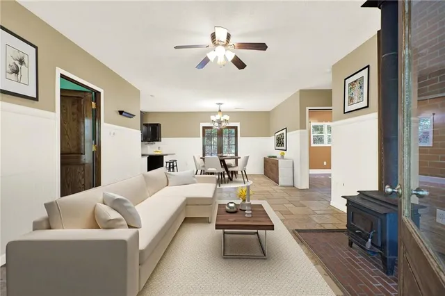a living room with furniture and a chandelier