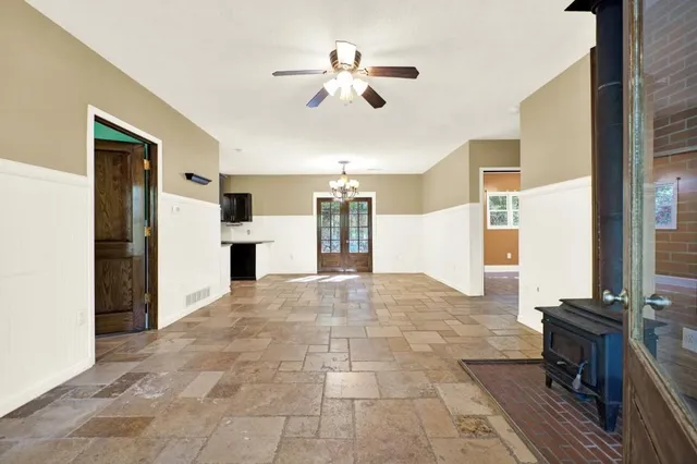 a view of a livingroom with furniture ceiling fan and windows
