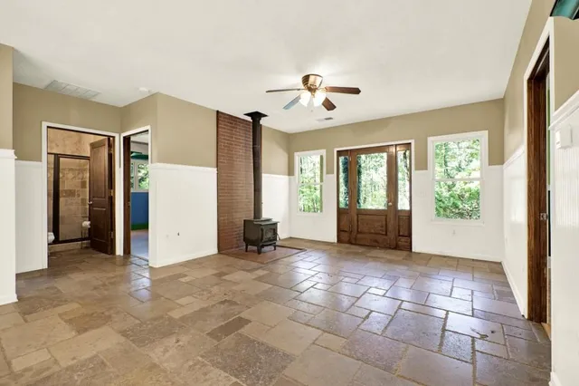 a living room with furniture and large windows
