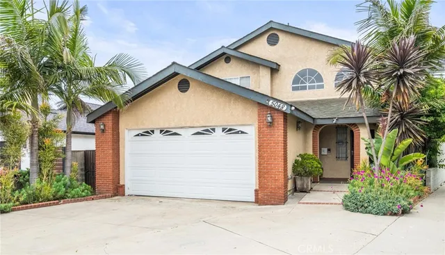 a view of a house with a small yard and plants
