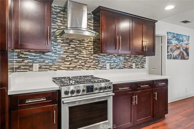 a kitchen with wooden cabinets and a stove top oven