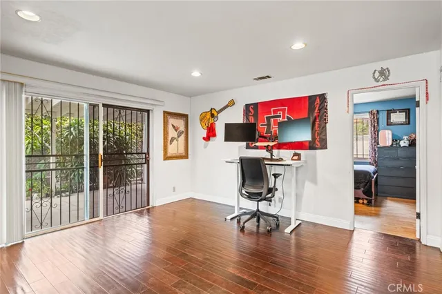 a view of a livingroom with wooden floor and white walls