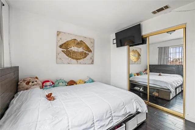 a bedroom with a bed and a flat screen tv