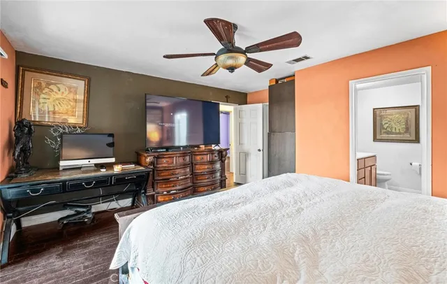 a bedroom with a bed and a flat screen tv