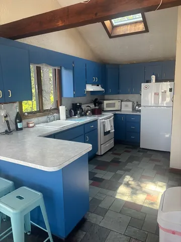 a kitchen with a stove a refrigerator and a refrigerator