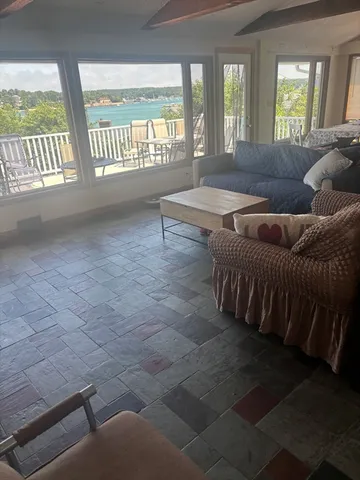 a living room with furniture and a floor to ceiling window