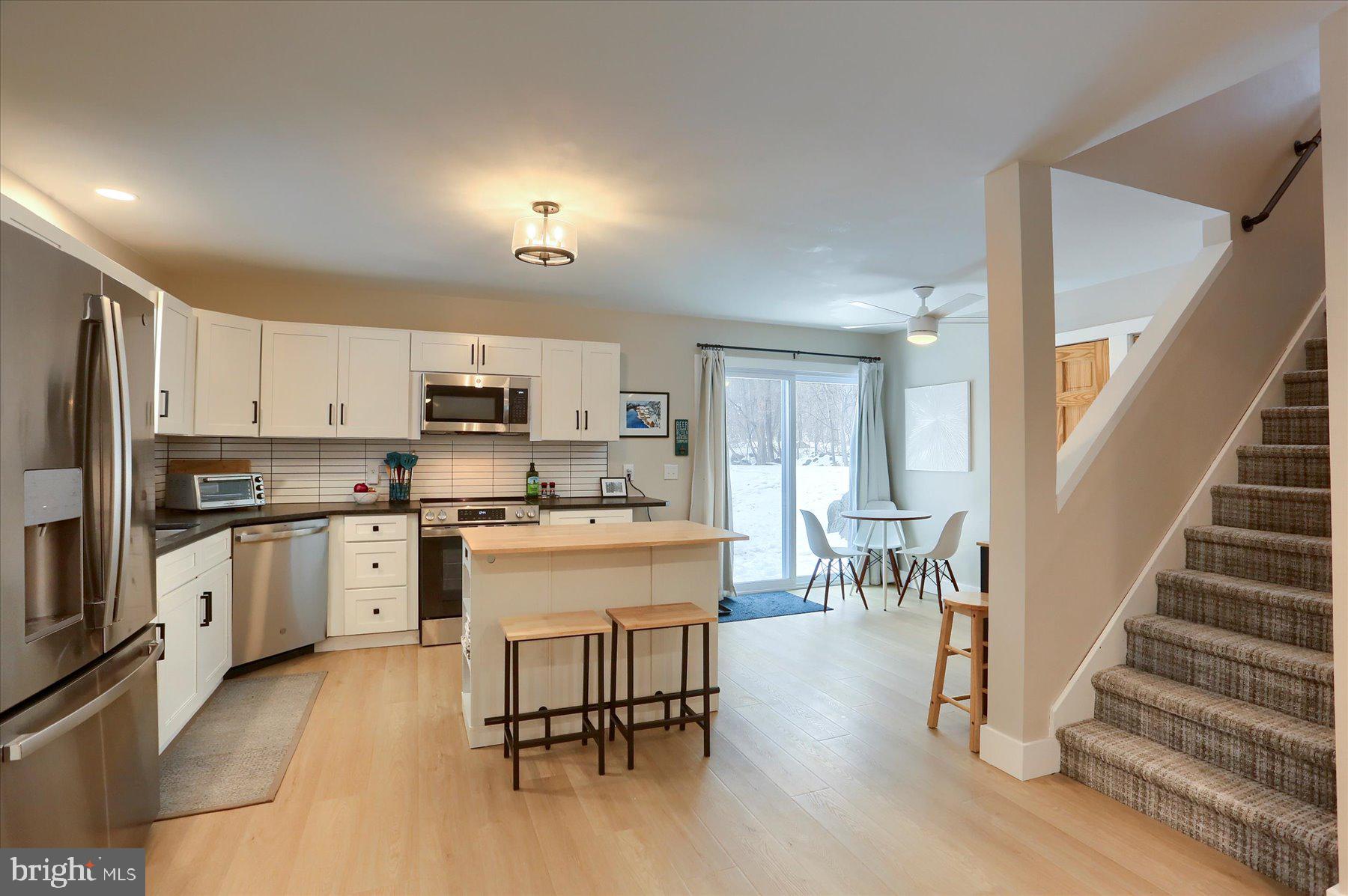 1365 Roundtop Road Lewisberry, PA 17339 - Photo 12 of 40 a kitchen with white cabinets and stainless steel appliances