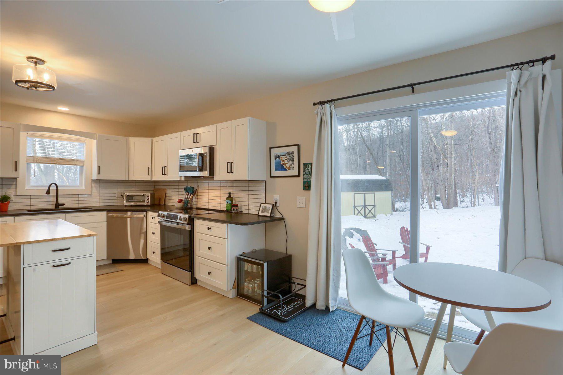 1365 Roundtop Road Lewisberry, PA 17339 - Photo 18 of 40 a kitchen with white cabinets and wooden floor
