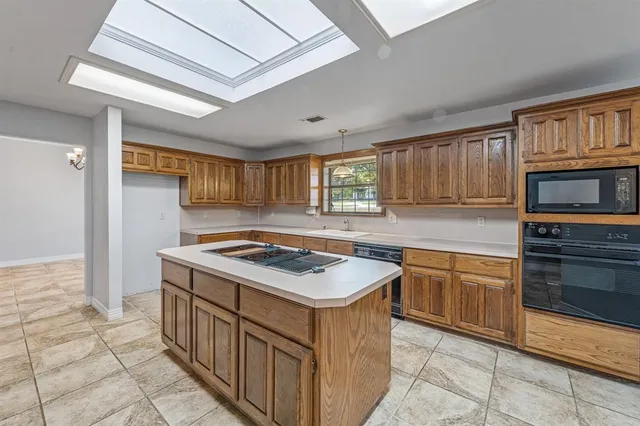 a kitchen with stainless steel appliances granite countertop a stove sink and cabinets