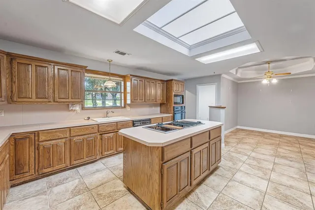 a kitchen with a stove sink and cabinets