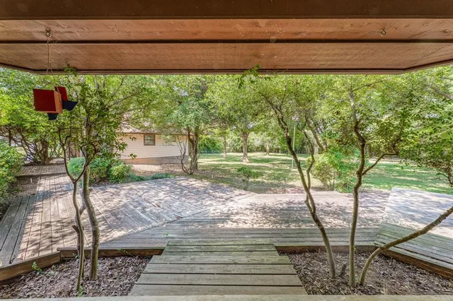 a view of a backyard with wooden floor