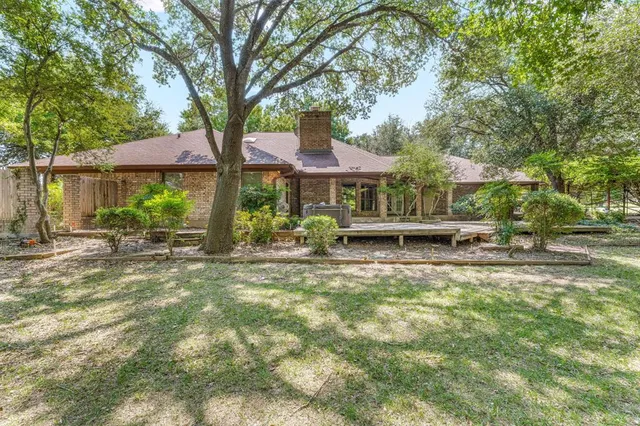 a view of a porch with chairs and backyard