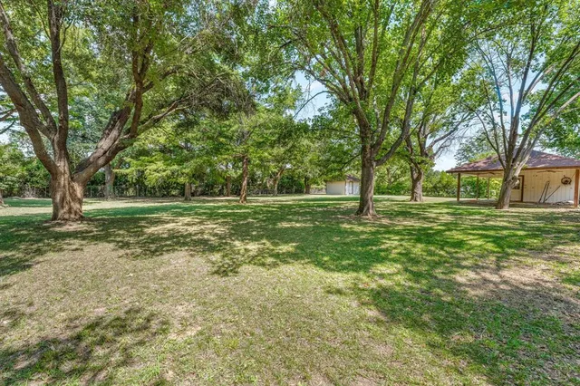a view of a house with yard and sitting area