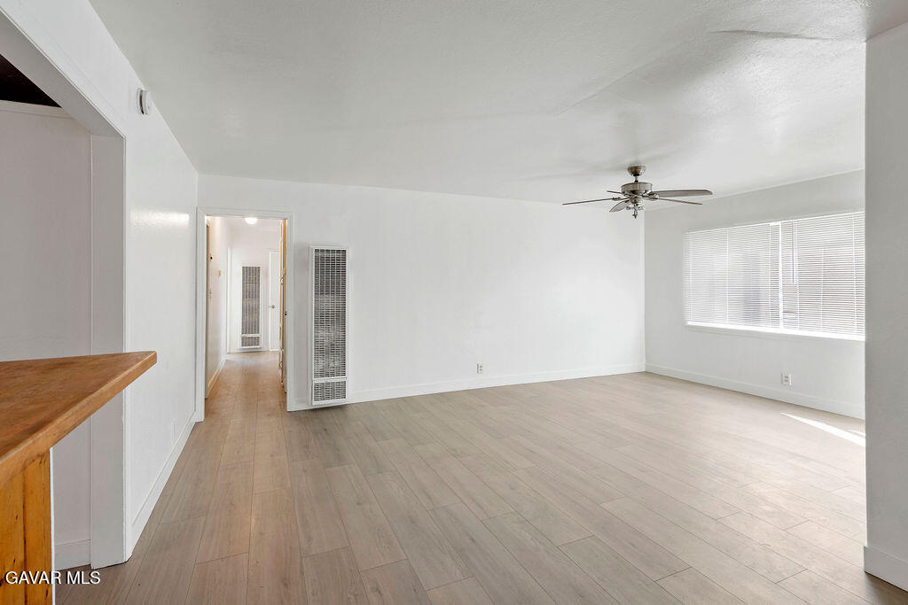 a view of a livingroom with a hardwood floor and staircase
