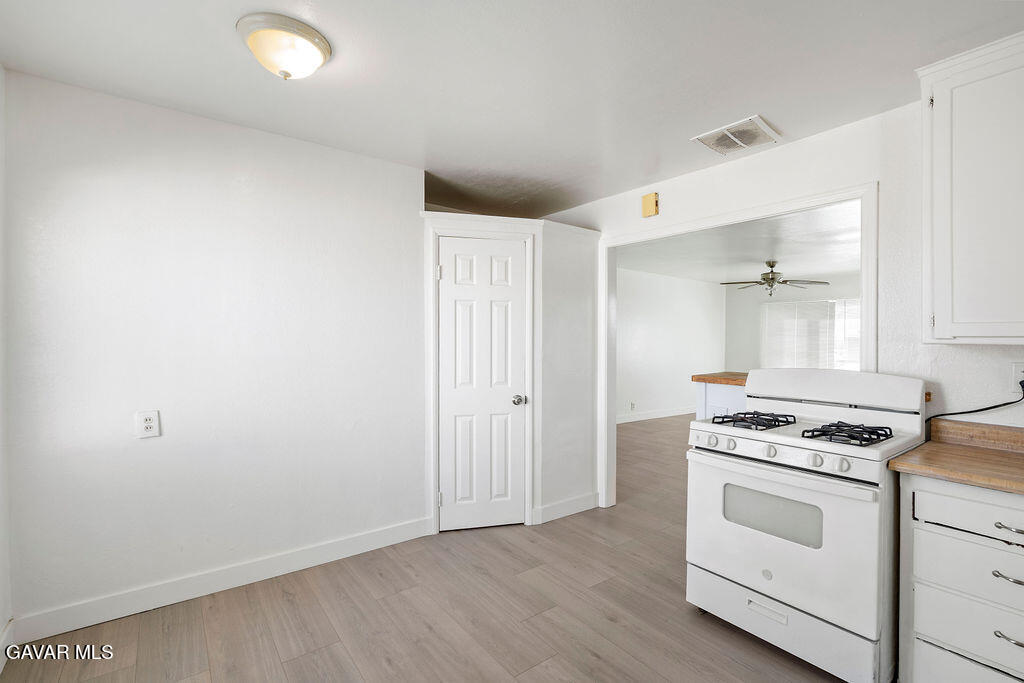 44152 Elm Avenue Lancaster, CA 93534 - Photo 4 of 17 a kitchen with white cabinets and white appliances