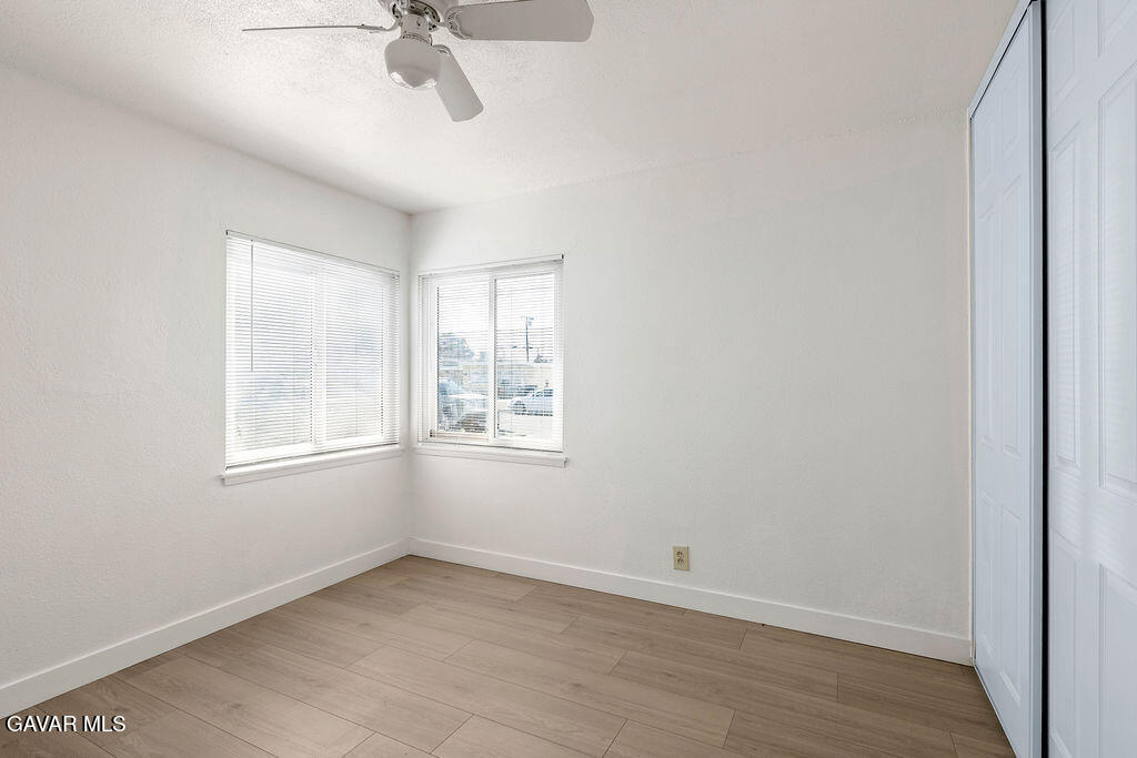 44152 Elm Avenue Lancaster, CA 93534 - Photo 7 of 17 an empty room with a window and a fan