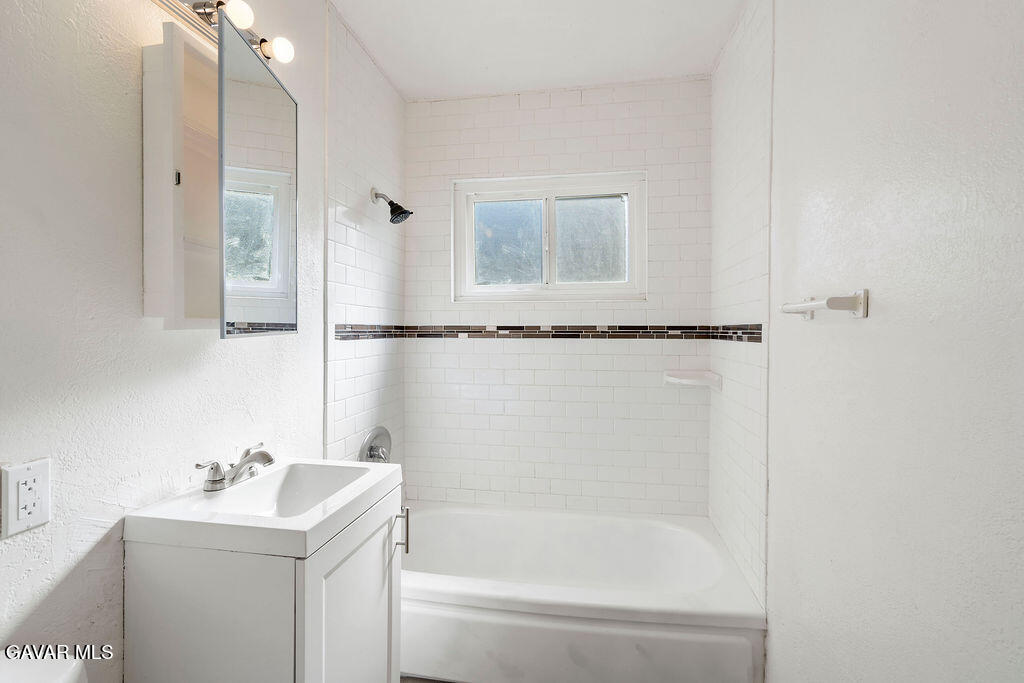 44152 Elm Avenue Lancaster, CA 93534 - Photo 8 of 17 a bathroom with a sink mirror and a bathtub