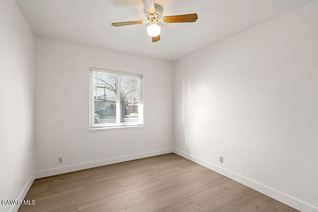 44152 Elm Avenue Lancaster, CA 93534 - Photo 10 of 17 an empty room with a window and a fan