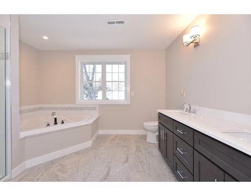 29 Brookdale Road Natick, MA 01760 - Photo 18 of 30 a bathroom with a bathtub a sink and a large mirror