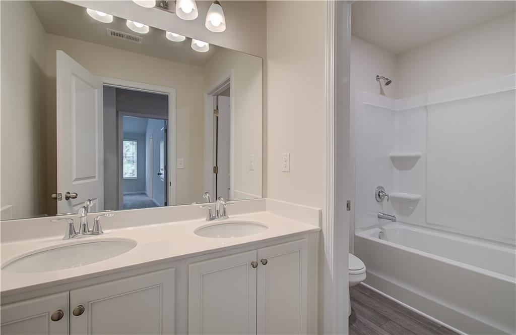 4501 Ajo Walk Atlanta, GA 30331 - Photo 15 of 16 a bathroom with a sink vanity tub and a mirror