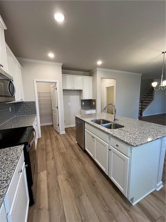 4501 Ajo Walk Atlanta, GA 30331 - Photo 7 of 16 a large kitchen with a center island wooden floor stainless steel appliances and cabinets