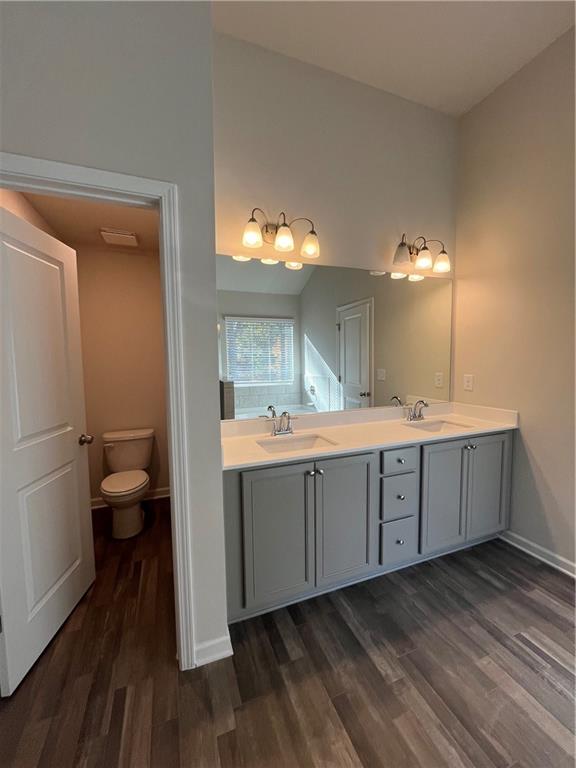 4501 Ajo Walk Atlanta, GA 30331 - Photo 10 of 16 a spacious bathroom with a double vanity sink toilet and a mirror