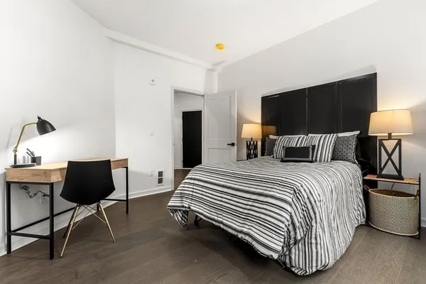 a bedroom with a bed and a flat screen tv