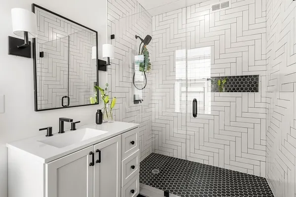 a bathroom with a sink a mirror and shower