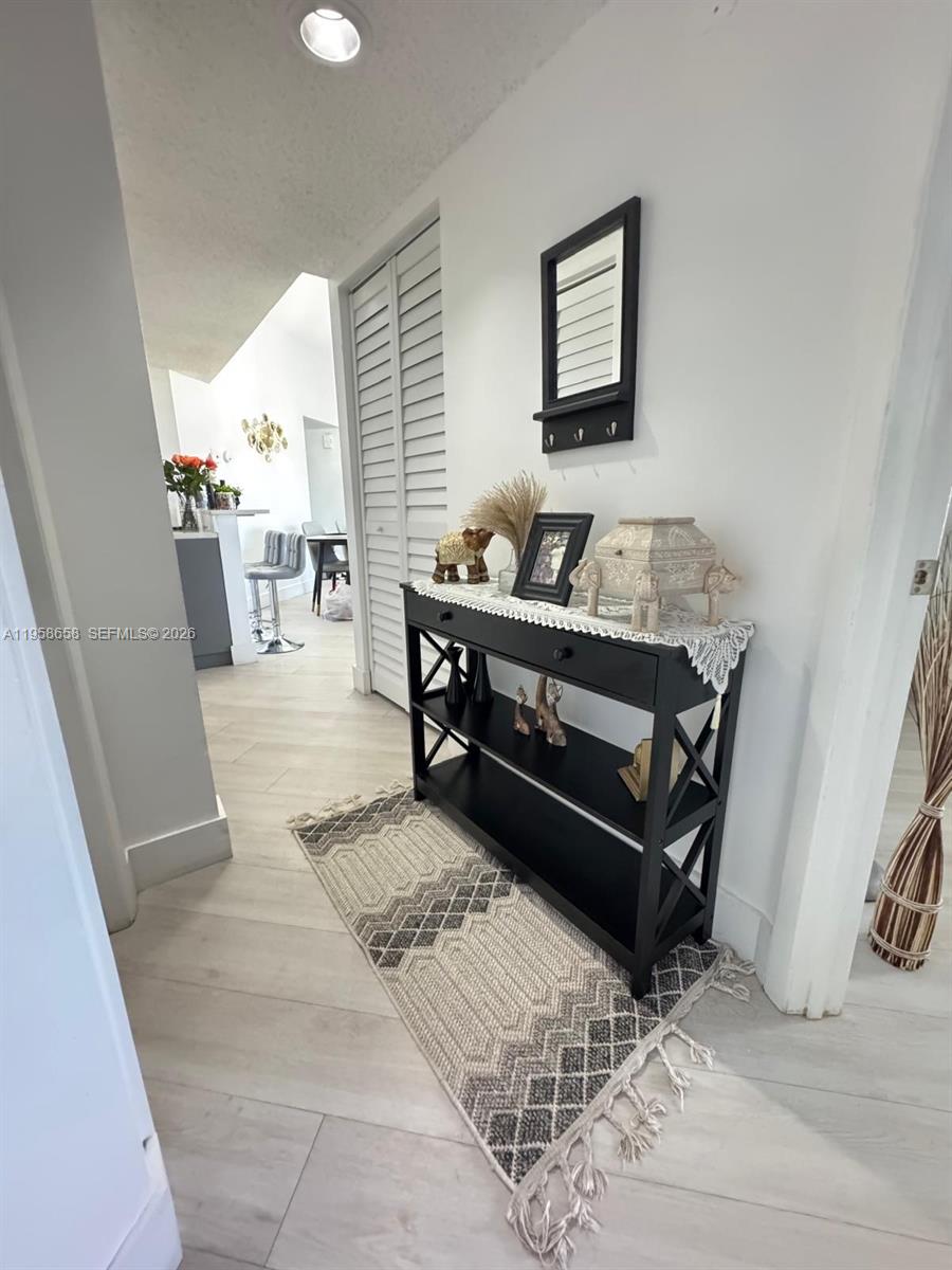 8801 Wiles Road, Unit 308 Coral Springs, FL 33067 - Photo 4 of 16 a living room with furniture and wooden floor