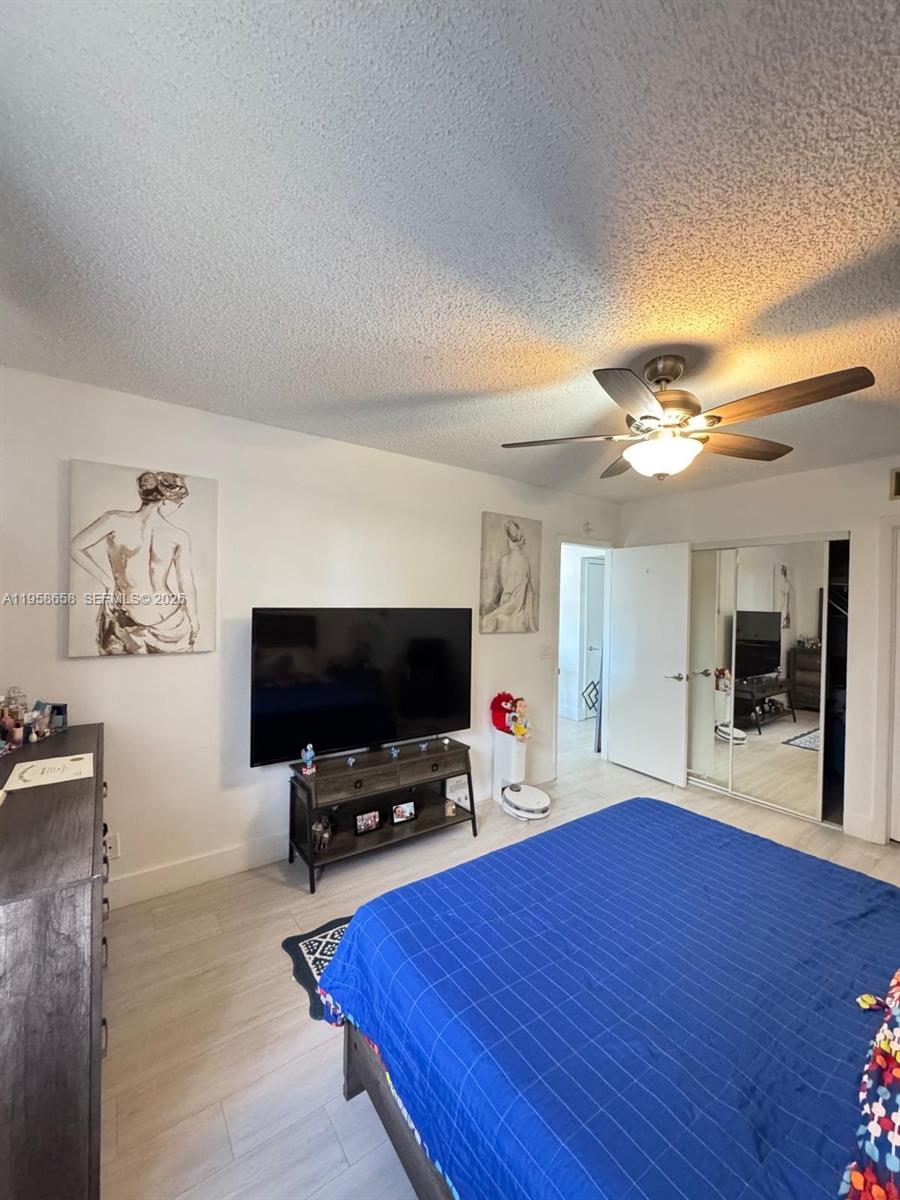 8801 Wiles Road, Unit 308 Coral Springs, FL 33067 - Photo 6 of 16 a living room with furniture and a flat screen tv
