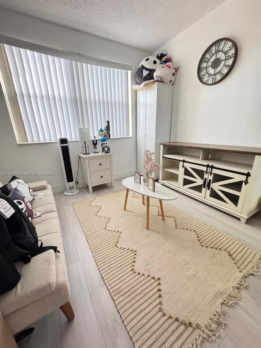 8801 Wiles Road, Unit 308 Coral Springs, FL 33067 - Photo 7 of 16 a living room with furniture