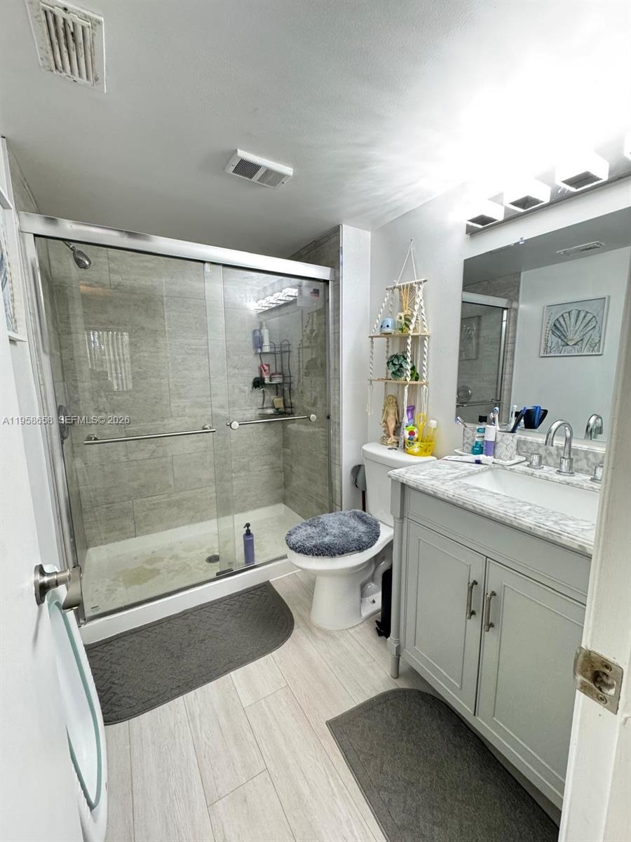 8801 Wiles Road, Unit 308 Coral Springs, FL 33067 - Photo 8 of 16 a bathroom with a bathtub shower sink mirror and toilet