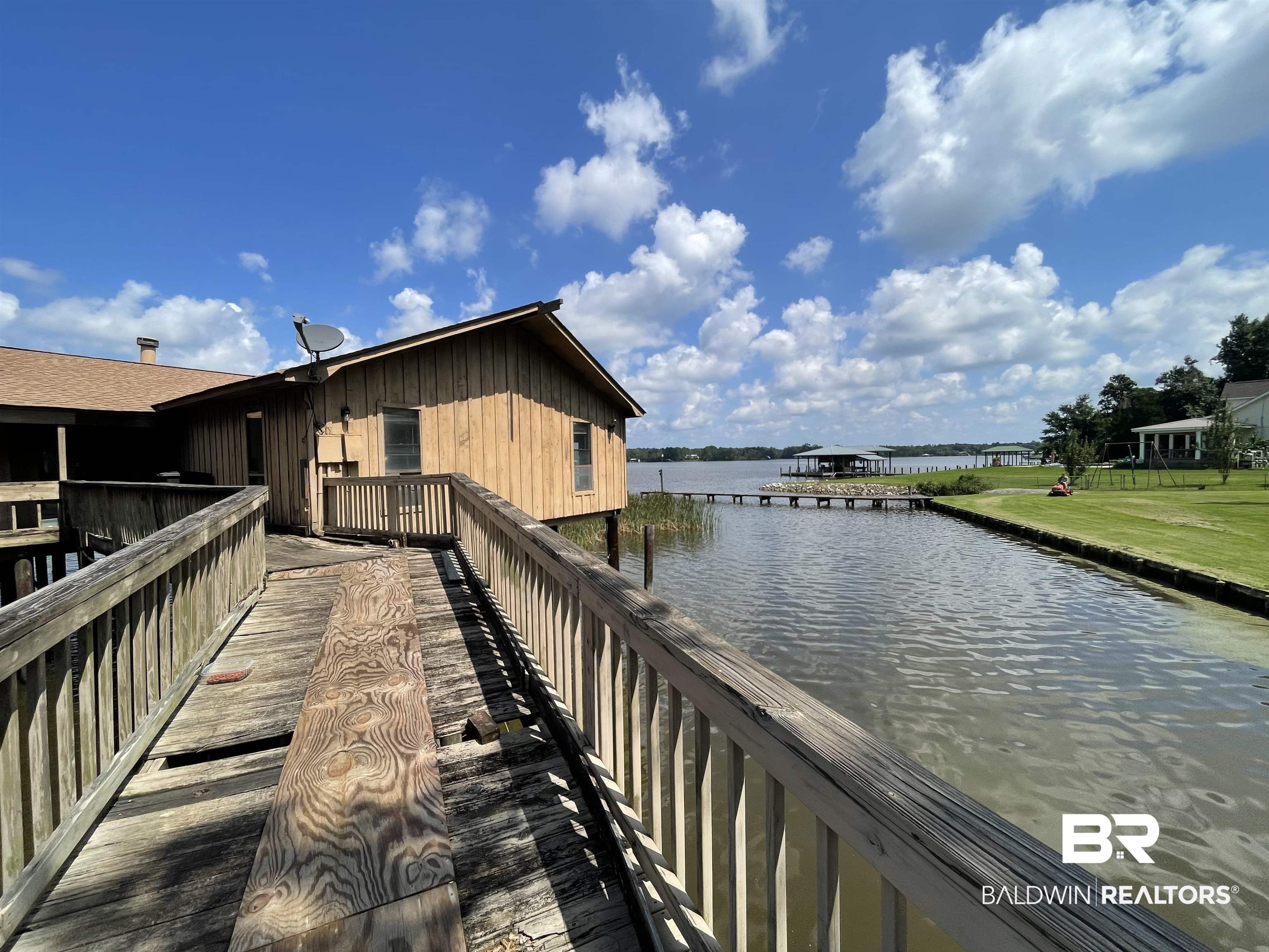 3074 Riverside Drive West Mobile, AL 36605 - Photo 3 of 15 Dock area featuring a water view and a lawn