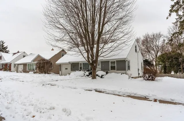 a view of a covered with snow in front of house