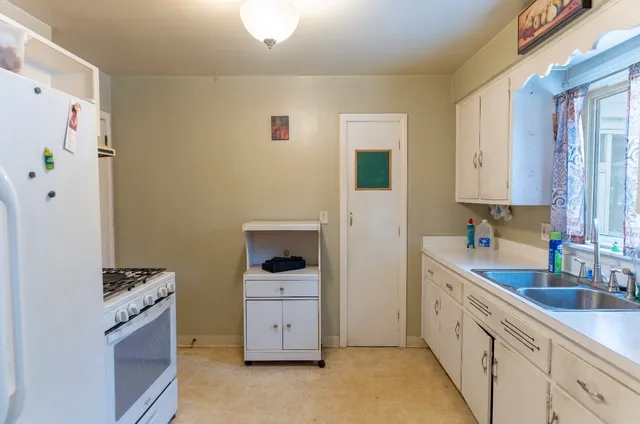 a kitchen with a refrigerator and a sink