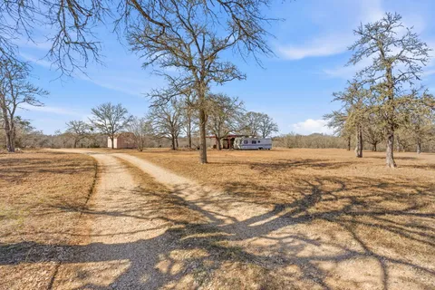 an aerial view of a house with a mountain