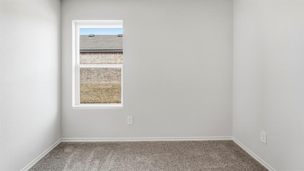 3535 Spring Time Street Forney, TX 75126 - Photo 20 of 23 Neutral interior walls featuring a single window and gray carpet flooring