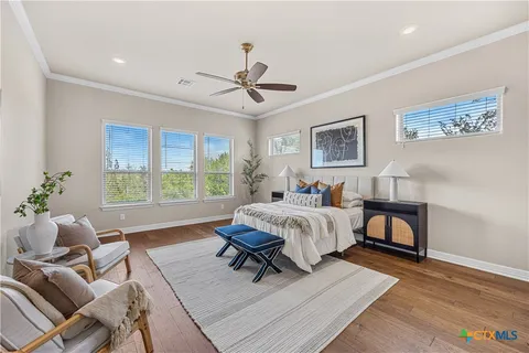 a spacious bedroom with a bed and a window