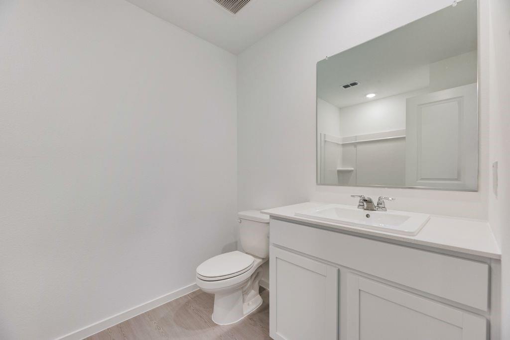 1272 Balsam Road Wilmer, TX 75172 - Photo 4 of 31 a bathroom with a toilet sink and mirror