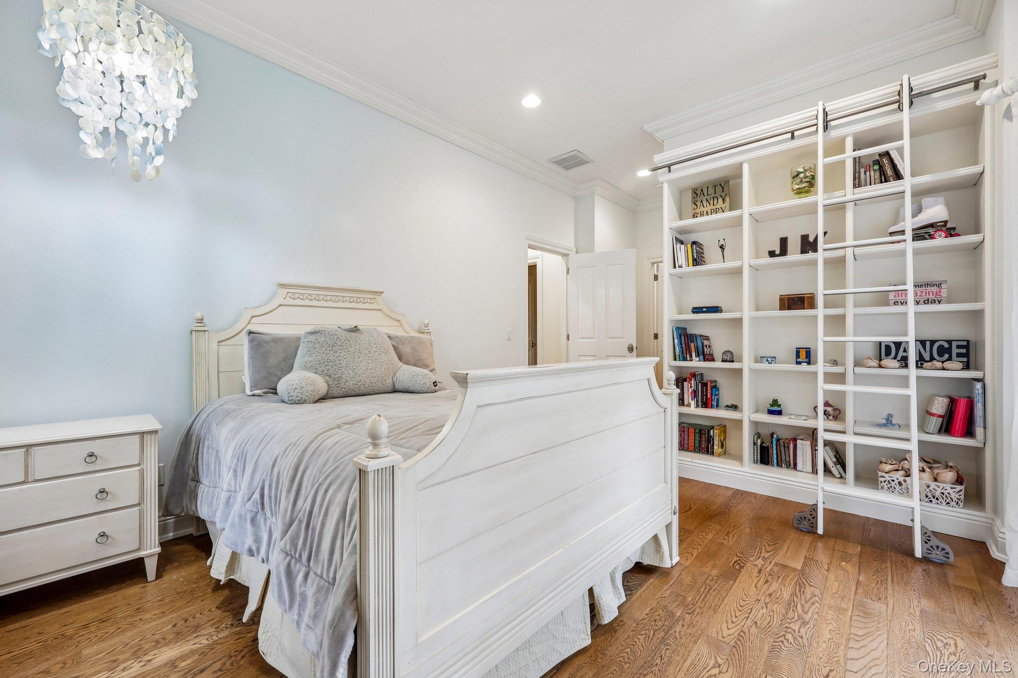 5 Mill Road Lloyd Harbor, NY 11743 - Photo 37 of 49 a bedroom with a bed and a book shelf