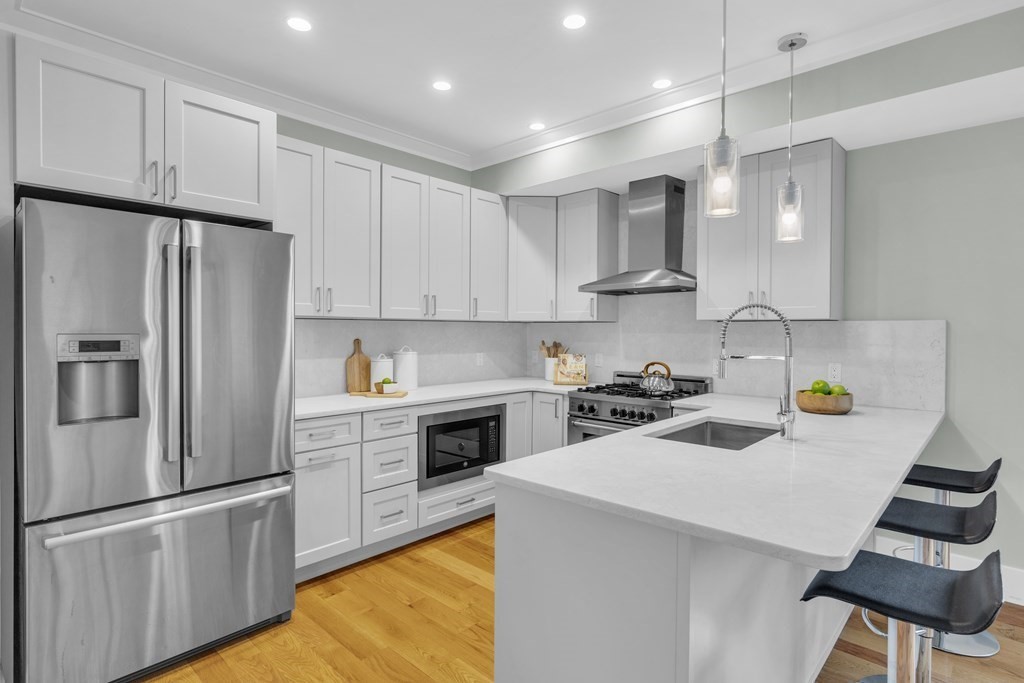 17 Vinton Street, Unit PH Boston, MA 02127 - Photo 11 of 36 a kitchen with stainless steel appliances a refrigerator sink and white cabinets