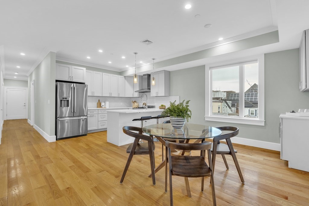 17 Vinton Street, Unit PH Boston, MA 02127 - Photo 13 of 36 a kitchen with a table and chairs in it