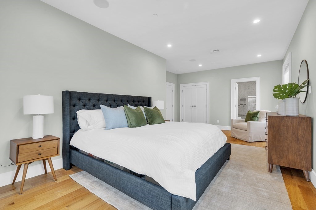 17 Vinton Street, Unit PH Boston, MA 02127 - Photo 19 of 36 a spacious bedroom with a bed and a couch