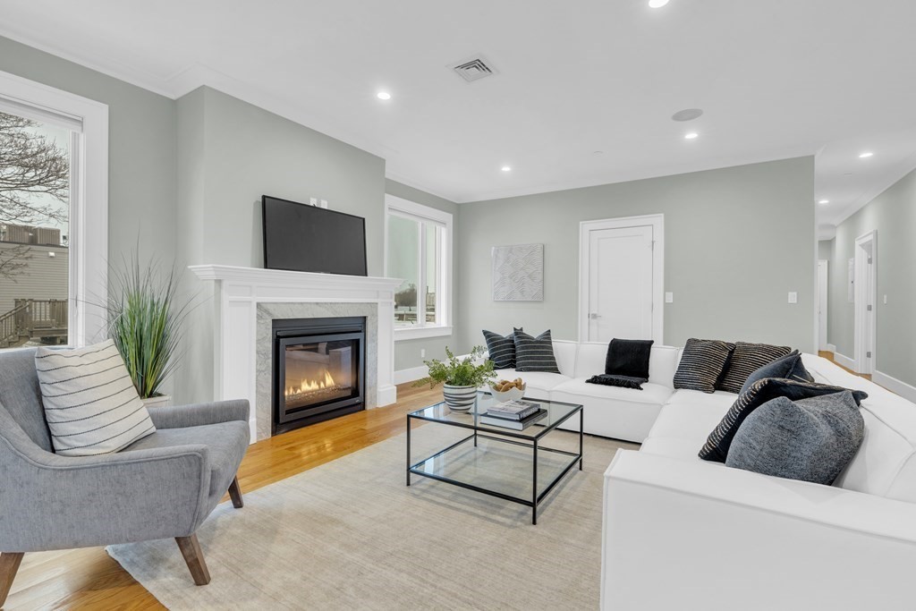 17 Vinton Street, Unit PH Boston, MA 02127 - Photo 2 of 36 a living room with furniture and a fireplace