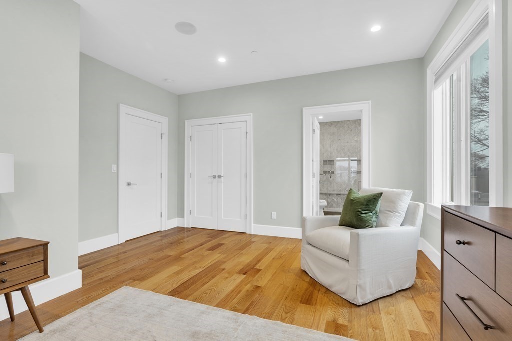 17 Vinton Street, Unit PH Boston, MA 02127 - Photo 22 of 36 a bedroom with a bed and a couch