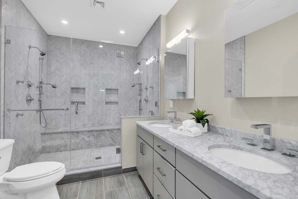 17 Vinton Street, Unit PH Boston, MA 02127 - Photo 25 of 36 a bathroom with a granite countertop sink a toilet and shower