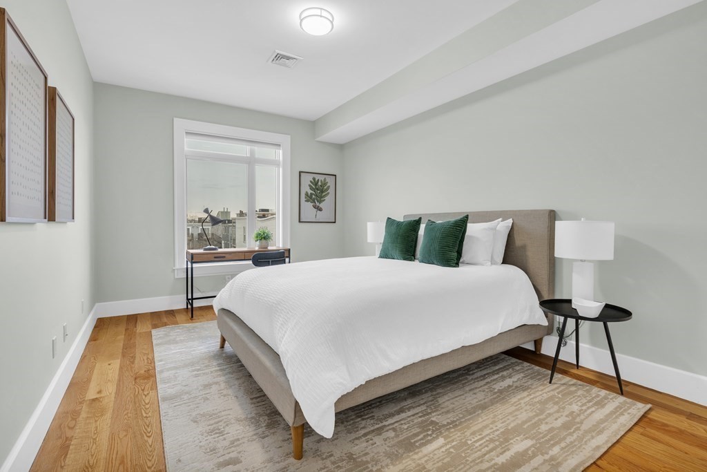 17 Vinton Street, Unit PH Boston, MA 02127 - Photo 26 of 36 a bedroom with a bed and a night stand