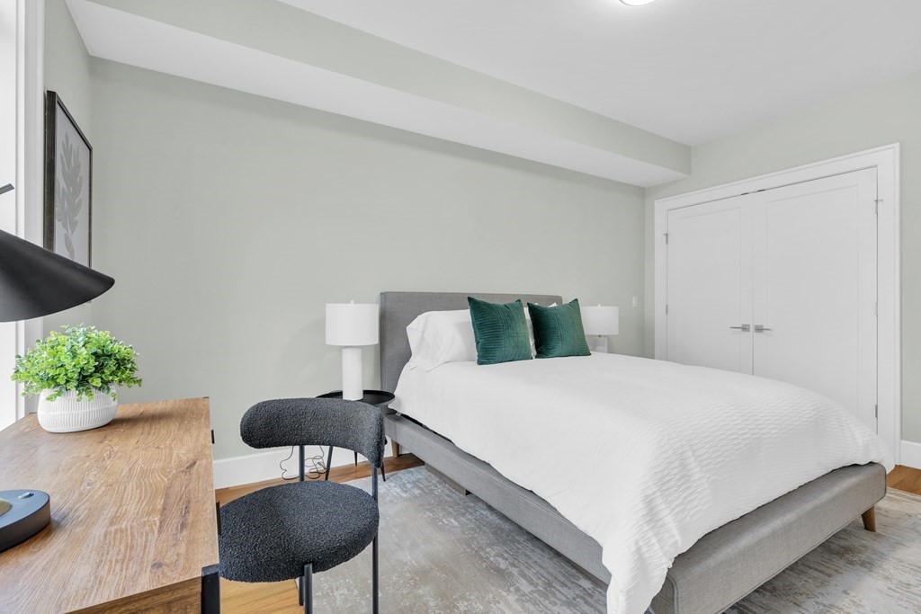 17 Vinton Street, Unit PH Boston, MA 02127 - Photo 28 of 36 a bedroom with a bed table and a chair