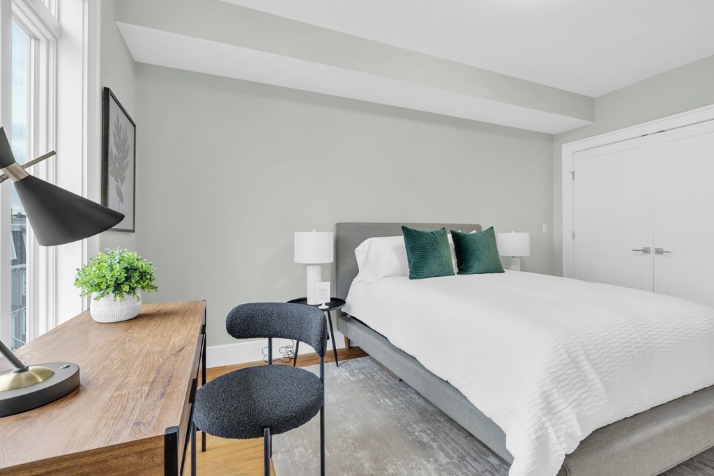 17 Vinton Street, Unit PH Boston, MA 02127 - Photo 29 of 36 a bedroom with a bed and a table